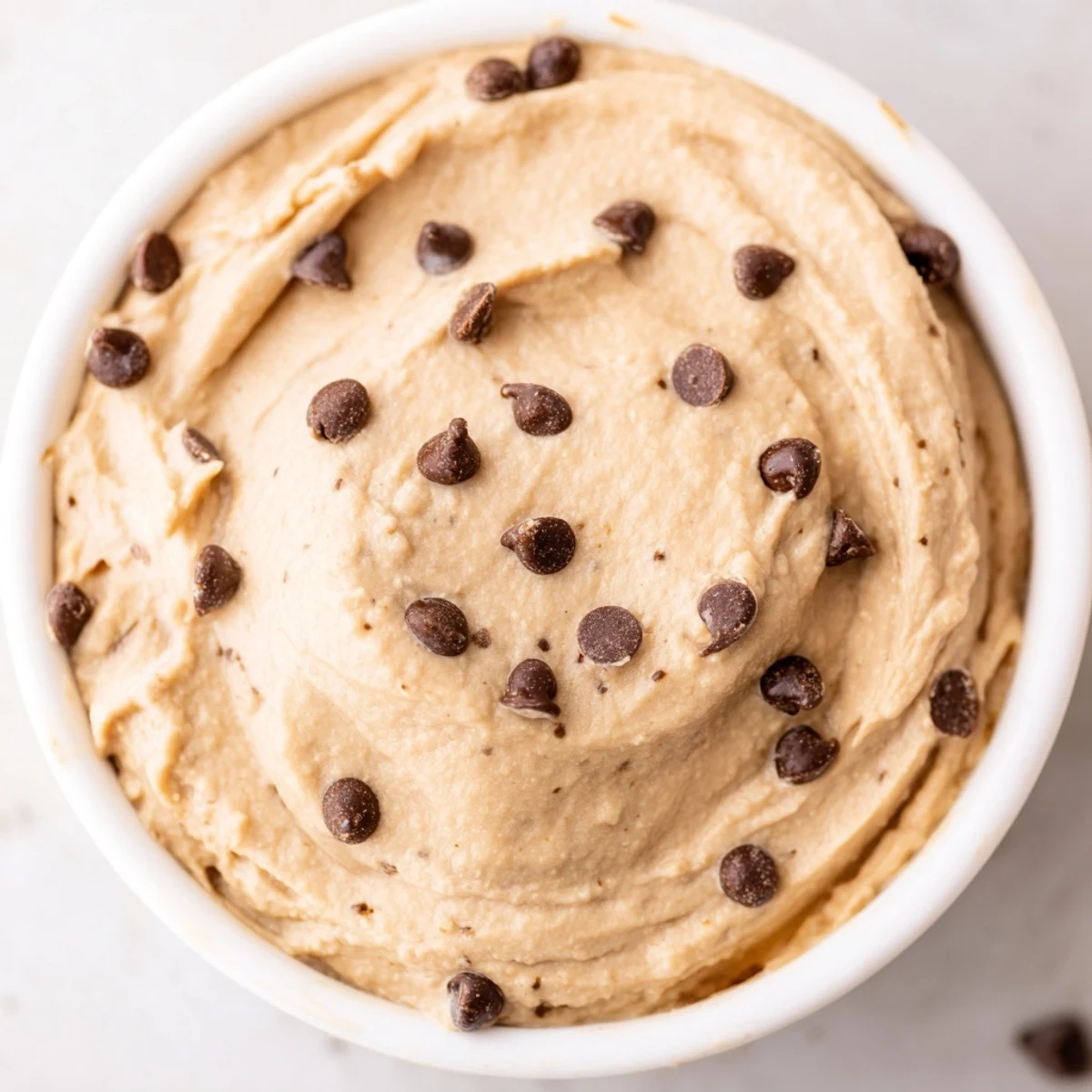 This wholesome Chocolate Chip Cookie Dough Hummus pairs perfectly with crisp apple slices for dipping.