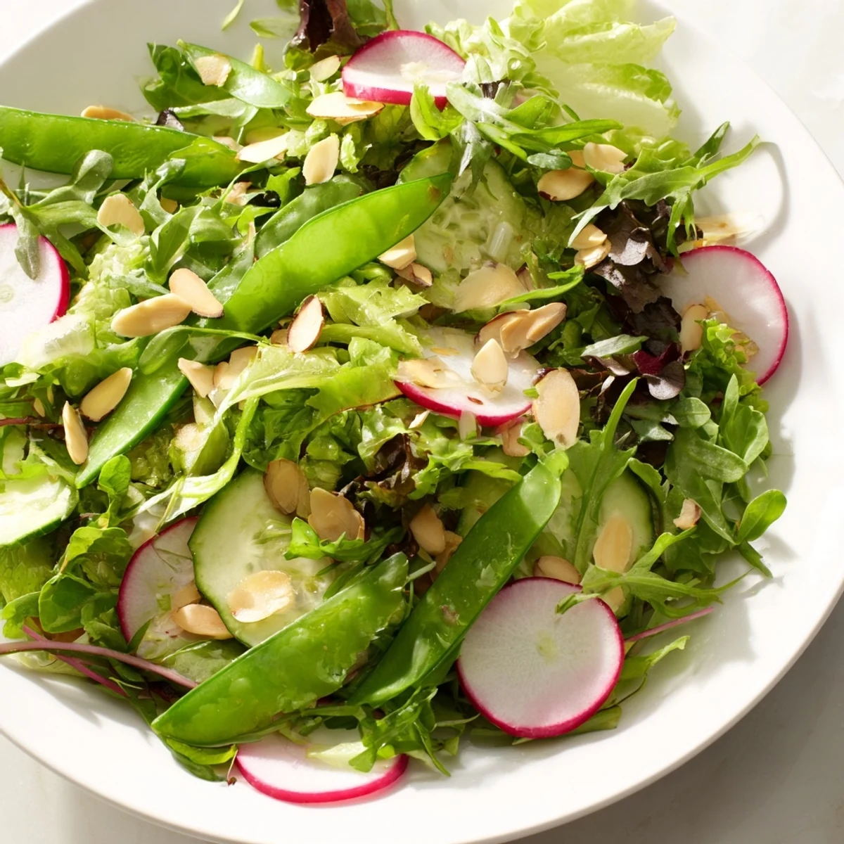 Freshly tossed Spring Greens Salad topped with crumbled goat cheese and toasted almonds, drizzled with a zesty, homemade lemon vinaigrette.