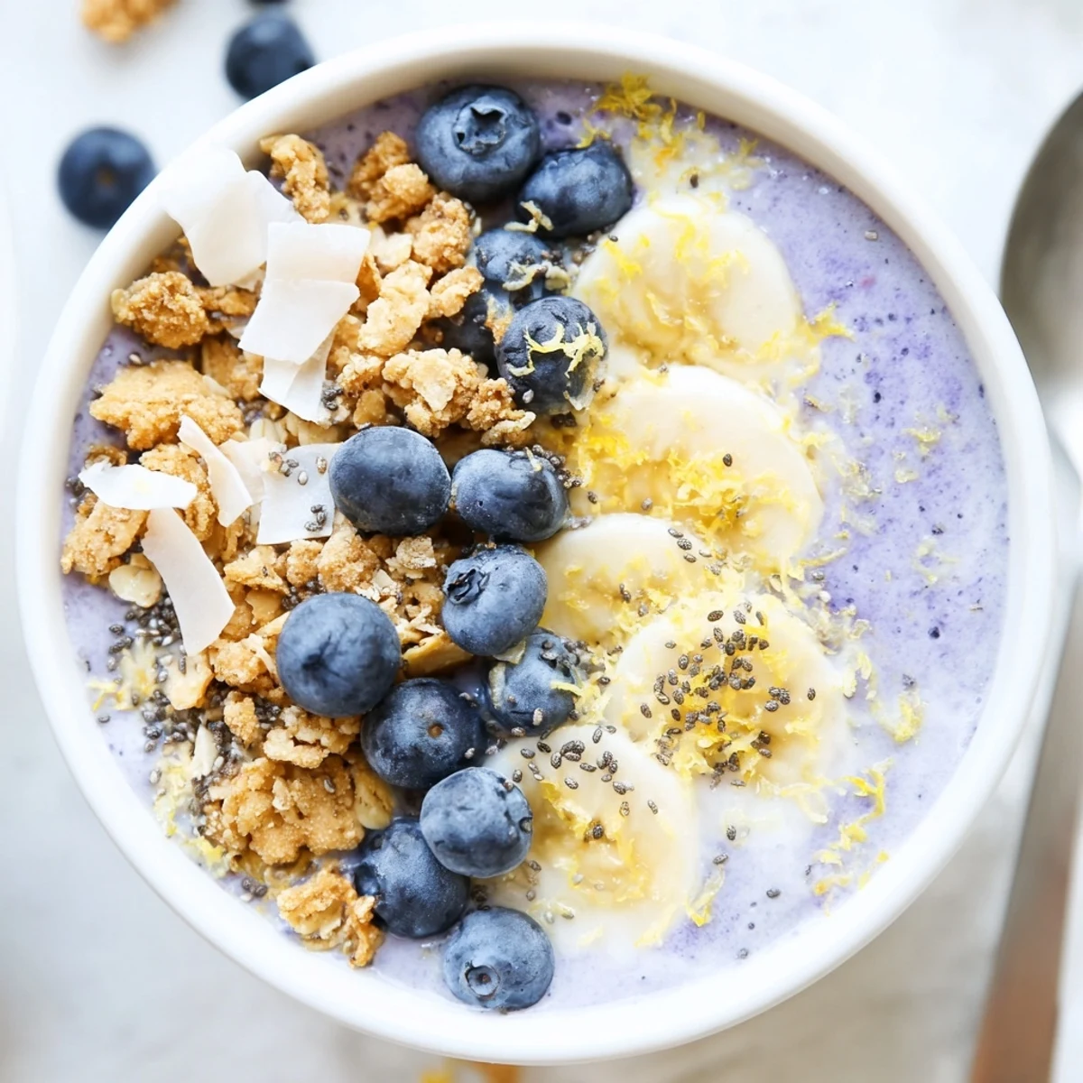 A refreshing Lemon Blueberry Smoothie Bowl with creamy blueberry-lemon base and crisp granola texture for breakfast. 
