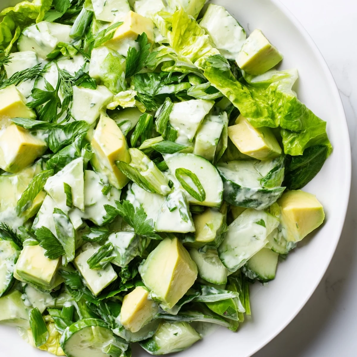 Sliced cucumbers and diced avocado are coated in tangy green goddess dressing in this refreshing Green Goddess Salad with Avocado and Cucumber.