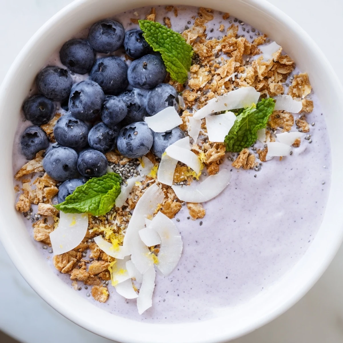 This healthy Lemon Blueberry Smoothie Bowl features a thick, creamy base with chia seeds and mint for a refreshing breakfast.