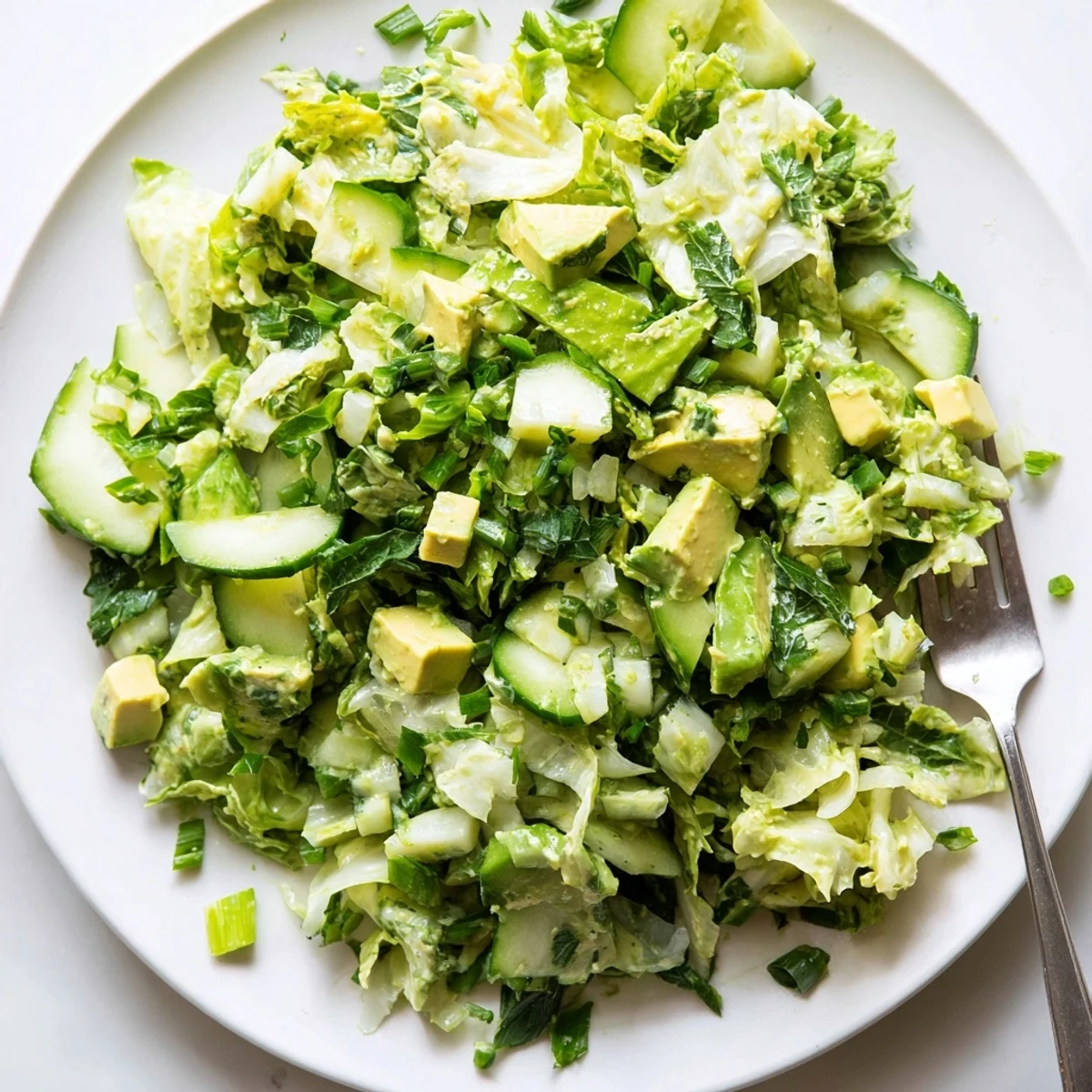Close-up of Green Goddess Salad with Avocado showing fresh herbs and cucumbers, served as a colorful light lunch for summer.
