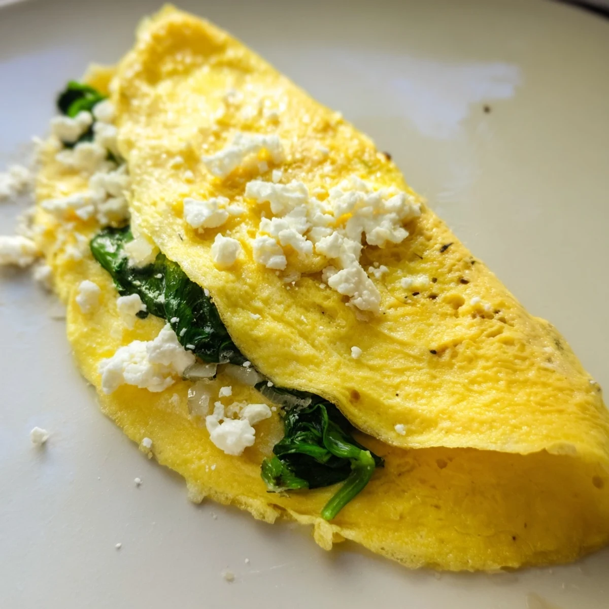 Steaming hot, the 15-Minute Spinach and Feta Omelet reveals a rich, creamy filling perfect for a quick Mediterranean breakfast.