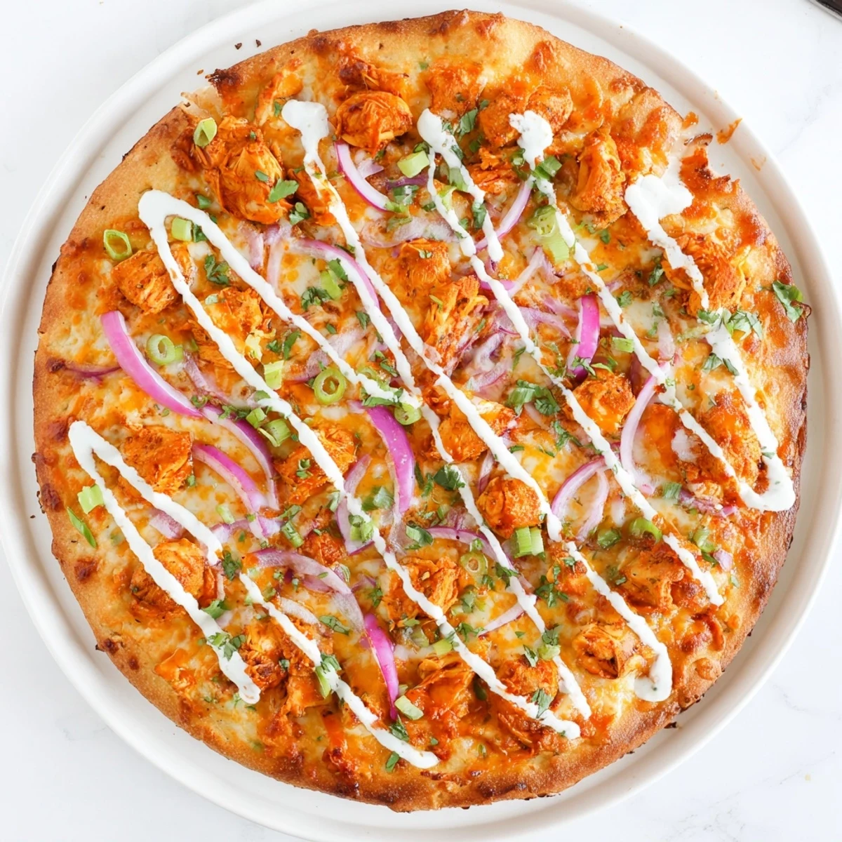 A slice of Bold Buffalo Chicken Pizza showing melted mozzarella and cheddar with buffalo chicken on a golden crust.