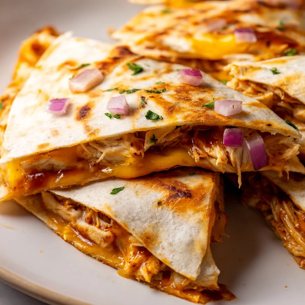 Golden-brown flour tortilla filled with shredded chicken coated in hot honey BBQ sauce and layers of melted mozzarella and cheddar.