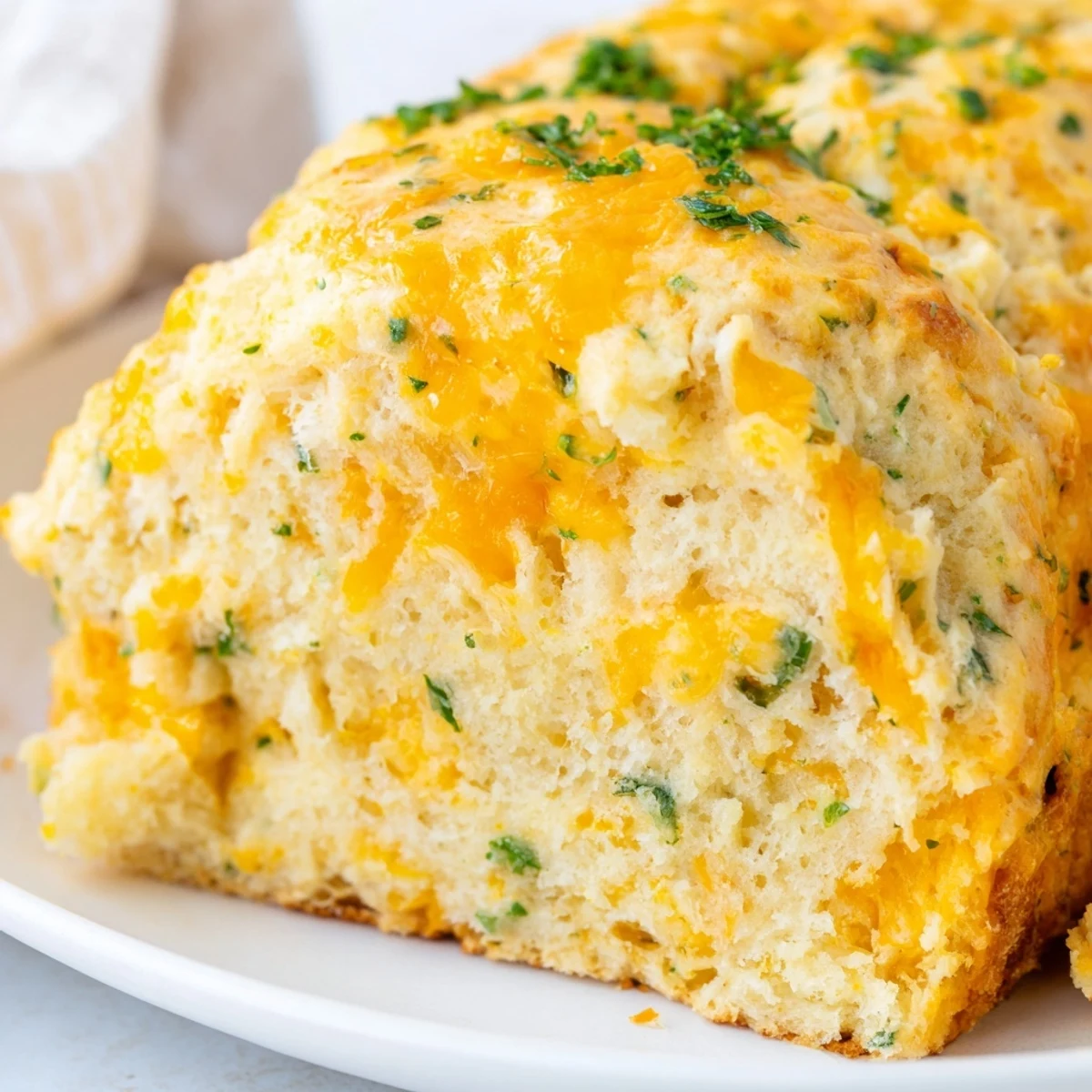 Warm, golden Red Lobsters Cheddar Bay Biscuit Loaf fresh from the oven, glistening with garlic butter.