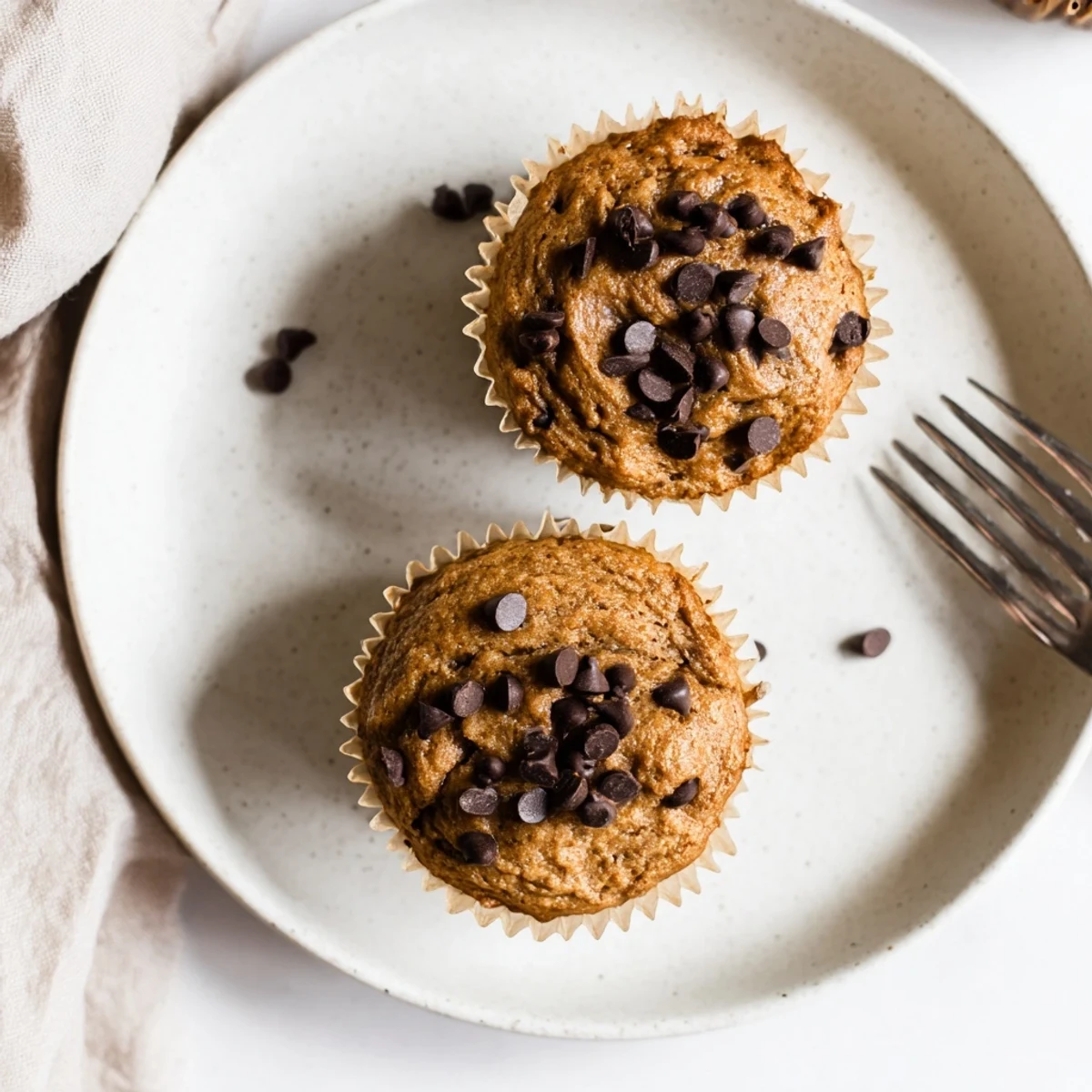 Freshly baked French Roast Coffee Muffins with Mochi Flour sit on a rustic wooden board, steam rising from the golden tops.