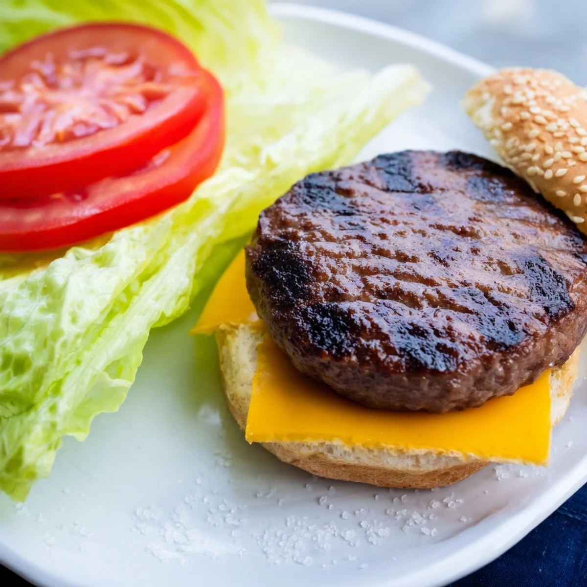 Juicy homemade hamburger patties fresh from the air fryer topped with crisp lettuce