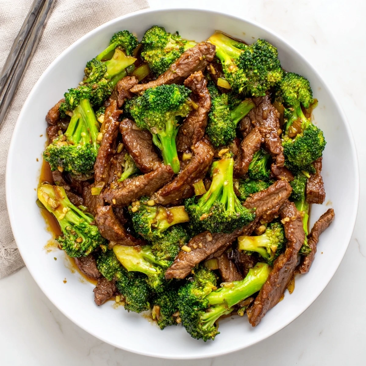 Sizzling wok with flank steak and crisp florets coated in rich brown Asian sauce