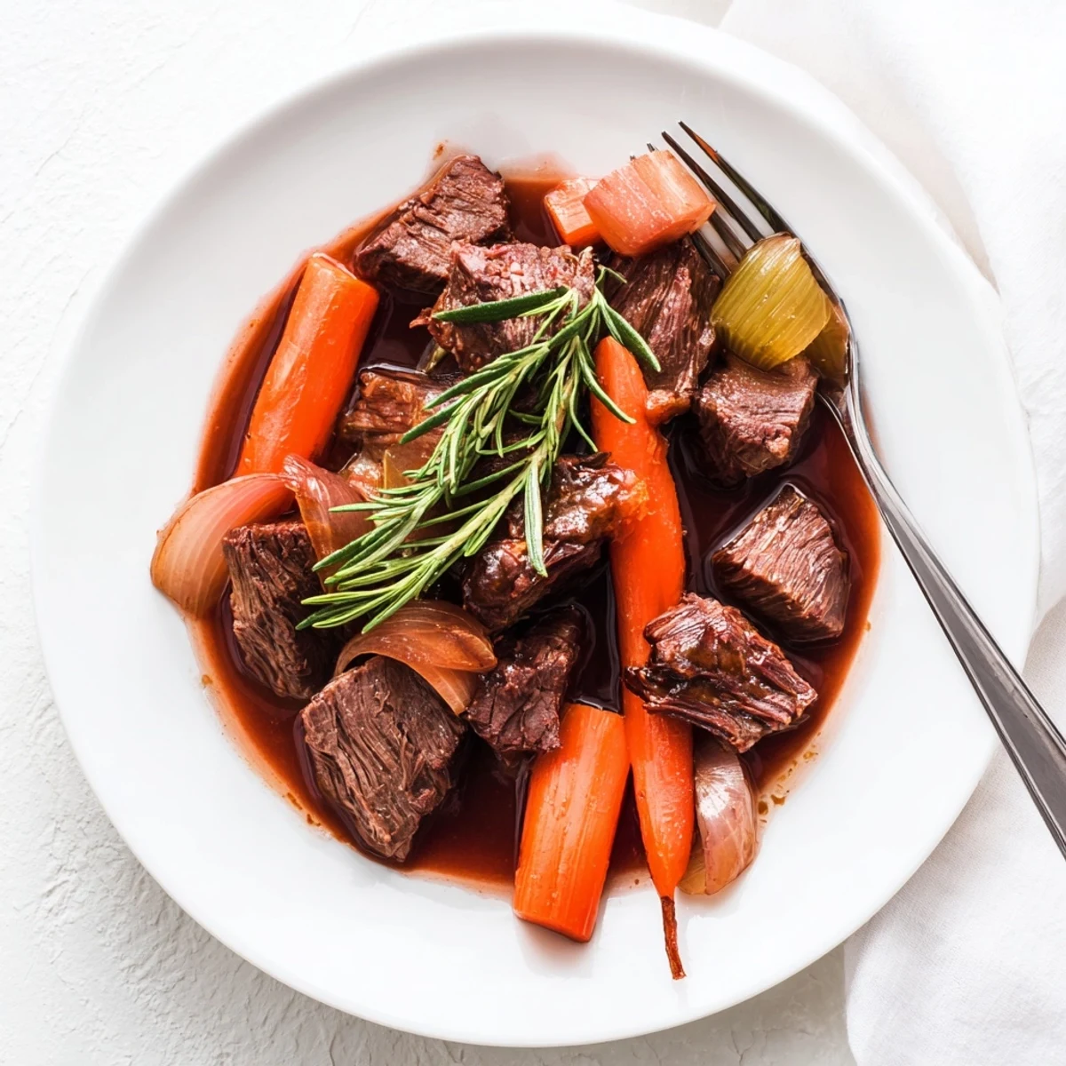Fork-tender grape juice braised chuck roast surrounded by tender carrots and celery