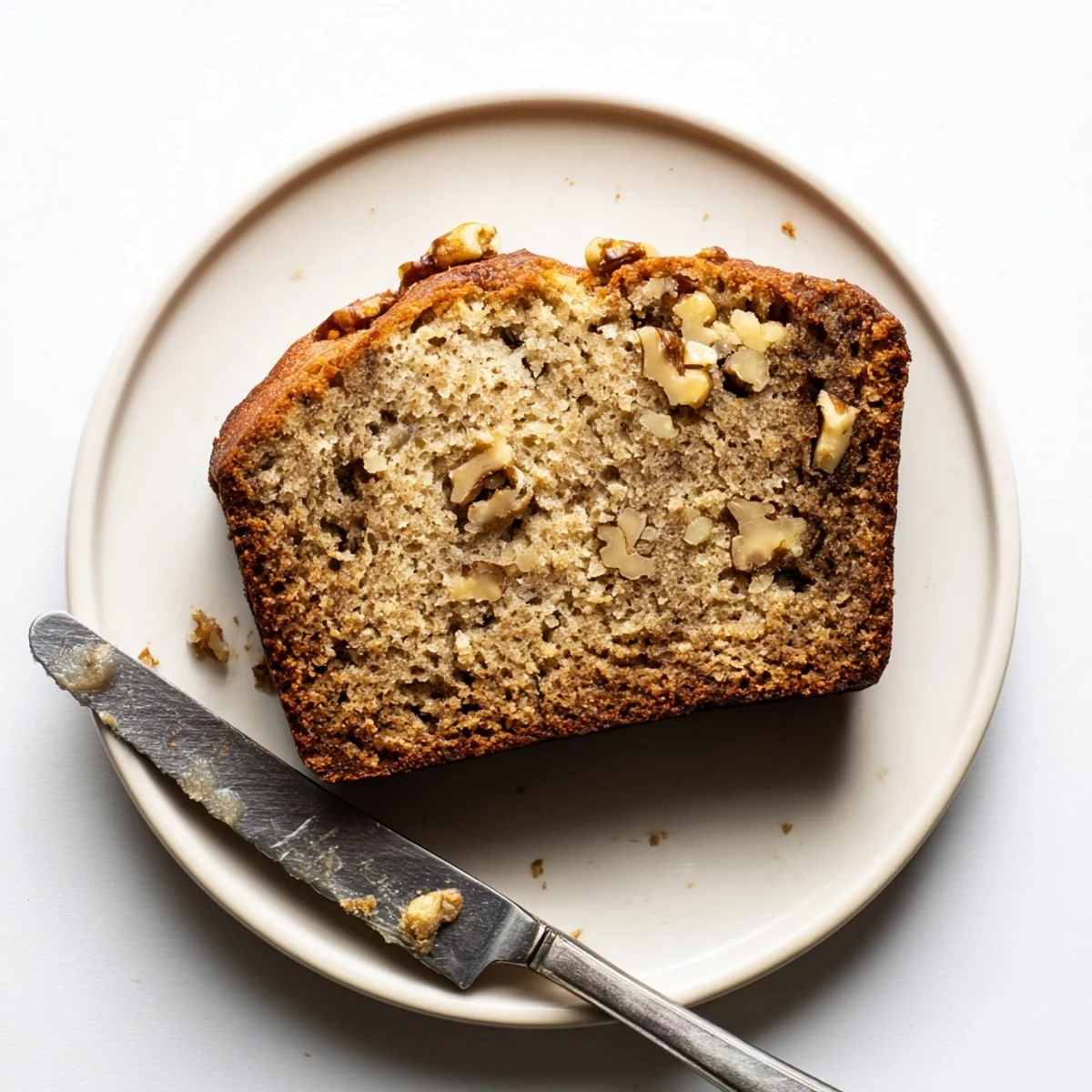 Freshly baked ultimate banana nut bread cooling on a wire rack with golden crust and visible walnut pieces
