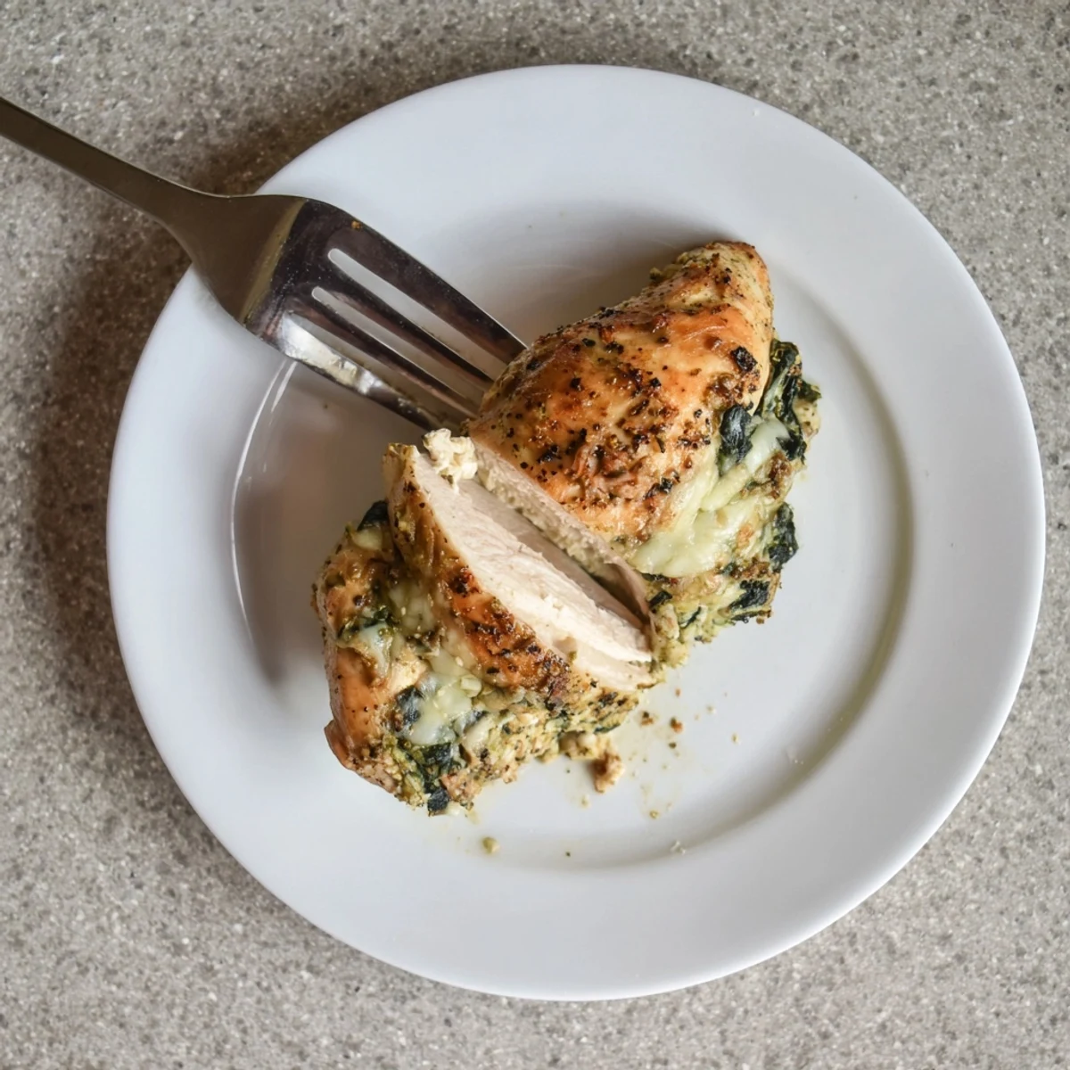Juicy chicken breasts stuffed with herb ricotta and spinach baked until golden brown with bubbly cheese