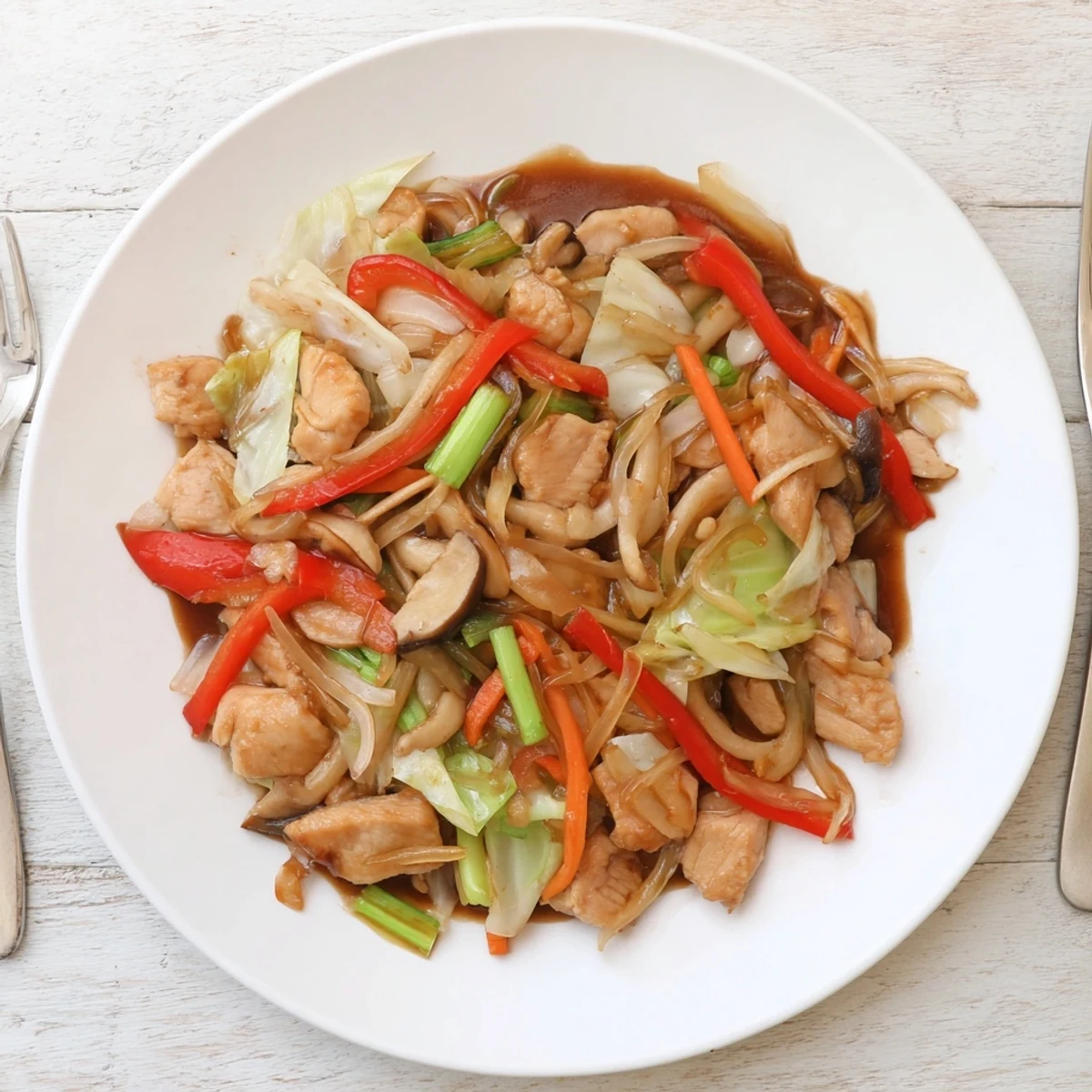 Colorful Chop Suey stir-fry featuring tender chicken, crisp vegetables, and glossy savory sauce served in a white bowl