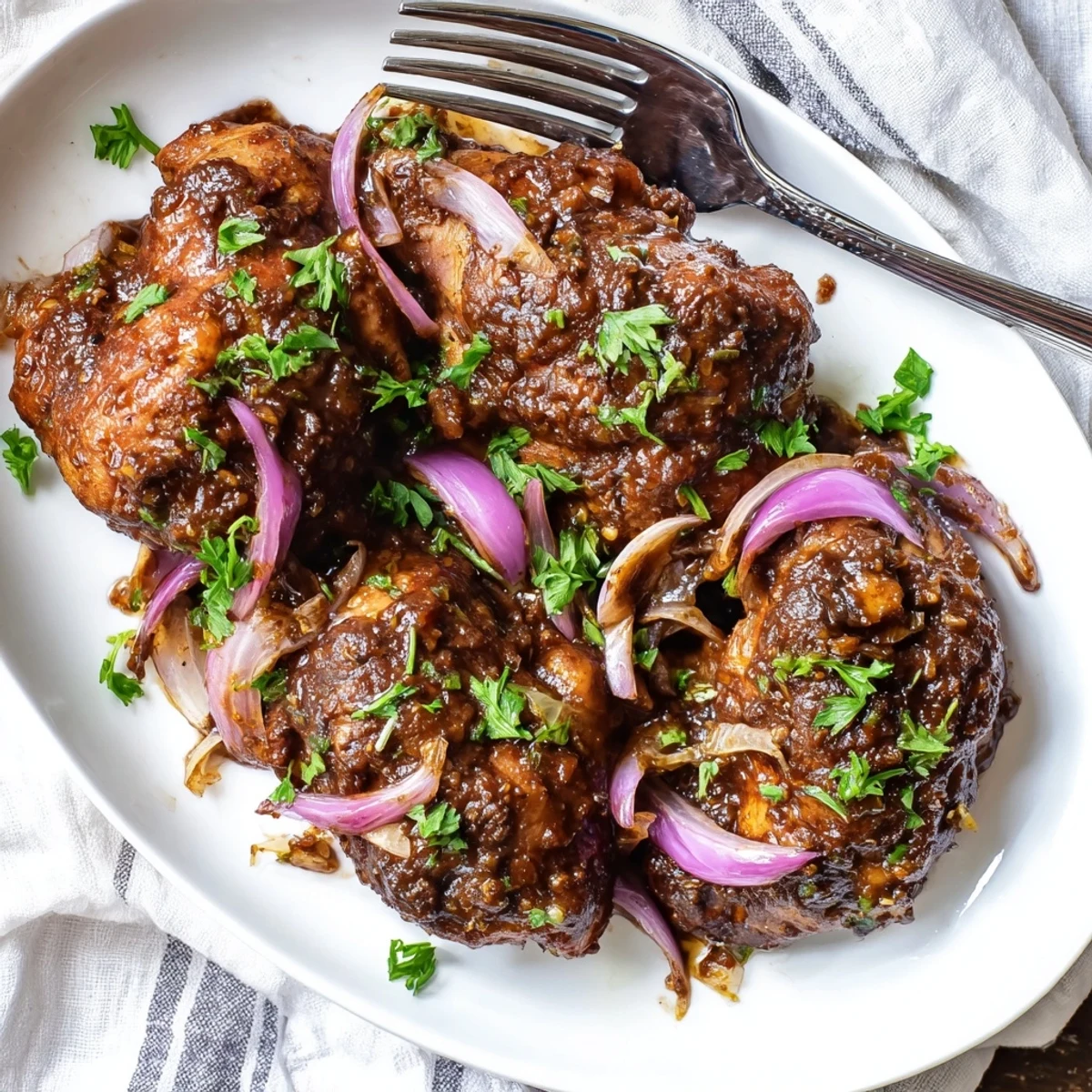 Tender chicken thighs slow-cooked in tangy balsamic vinegar sauce served over fluffy white rice
