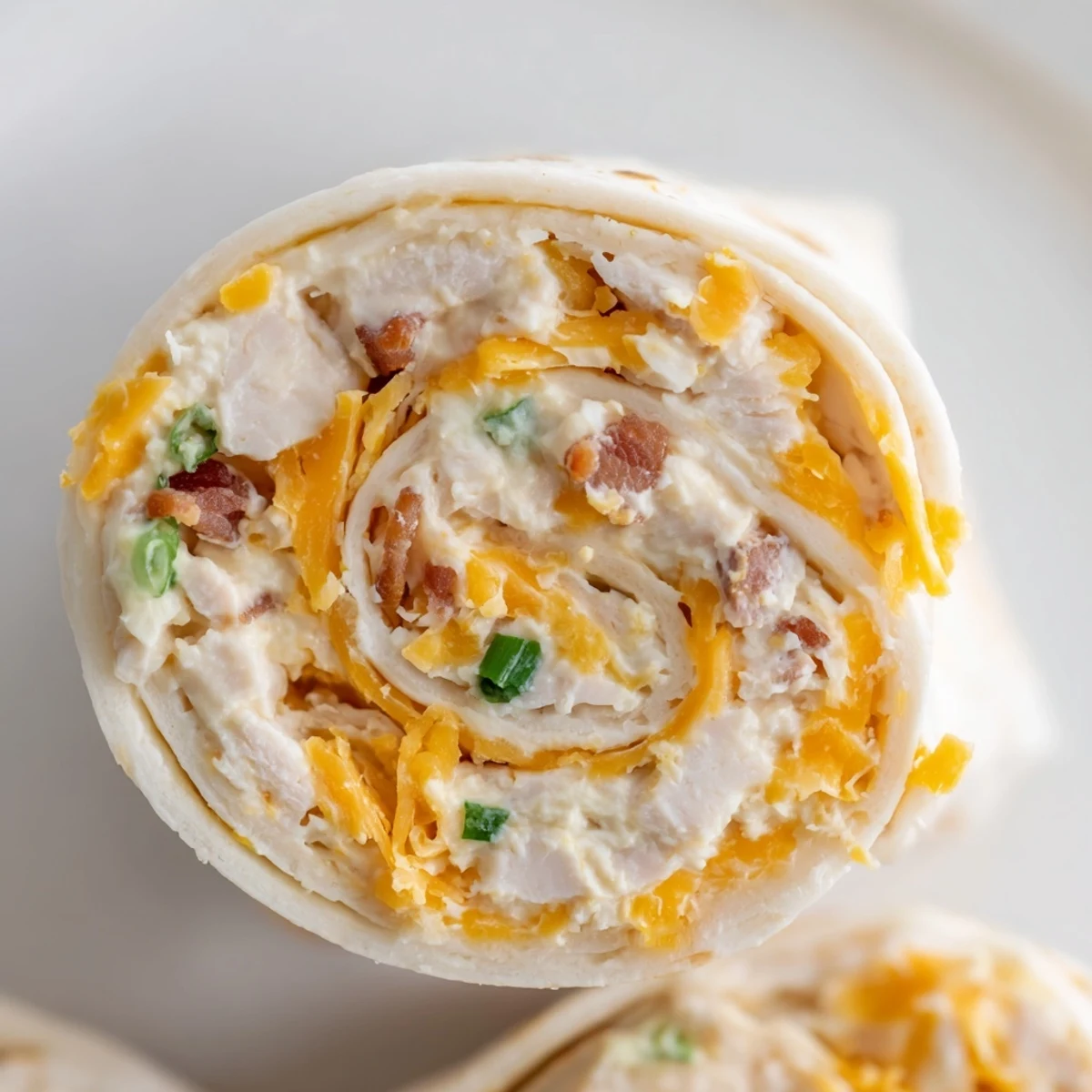 Spiral sliced tortilla pinwheels filled with creamy crack chicken mixture and crispy bacon bits