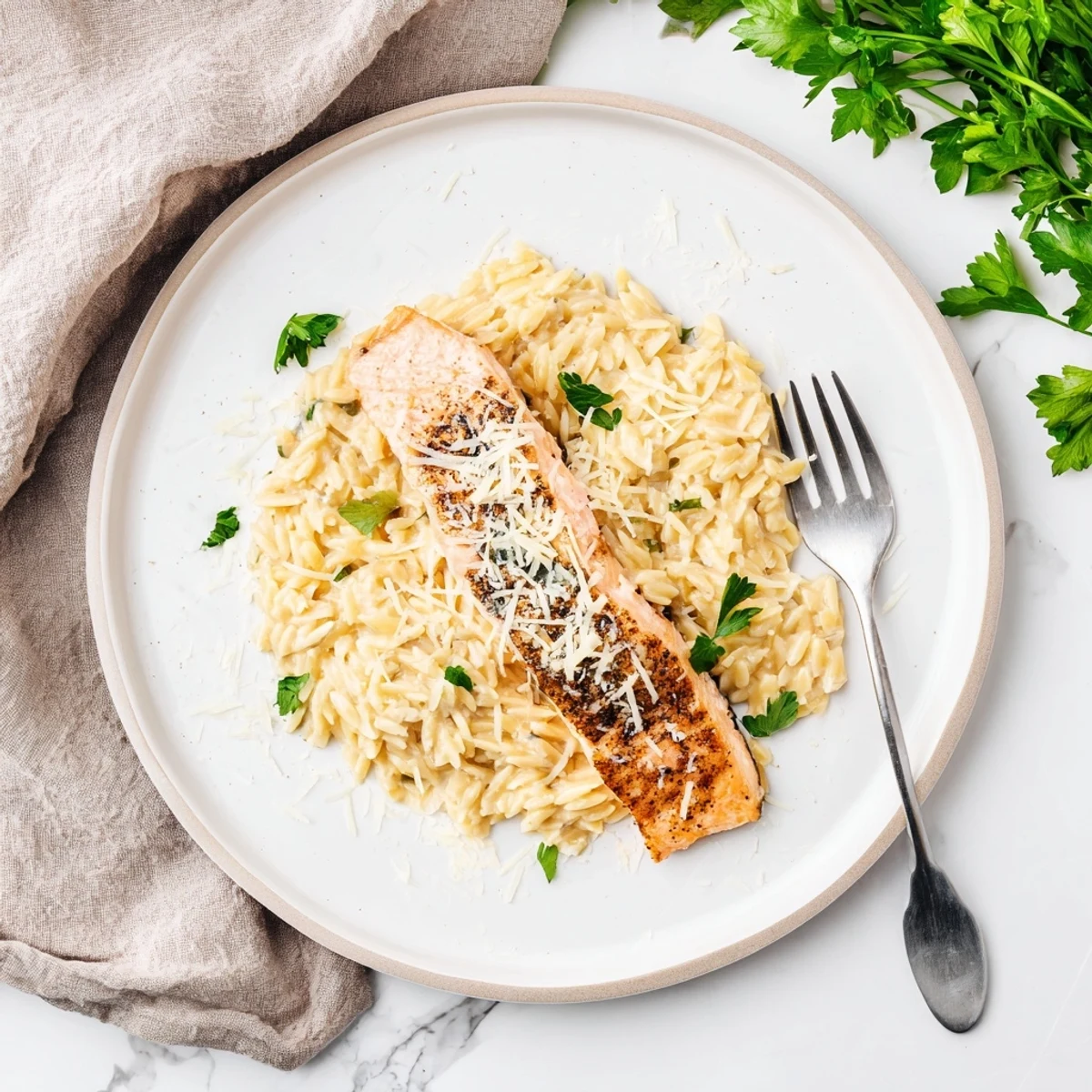 One skillet salmon with lemon orzo featuring flaky fish and bright citrus zest