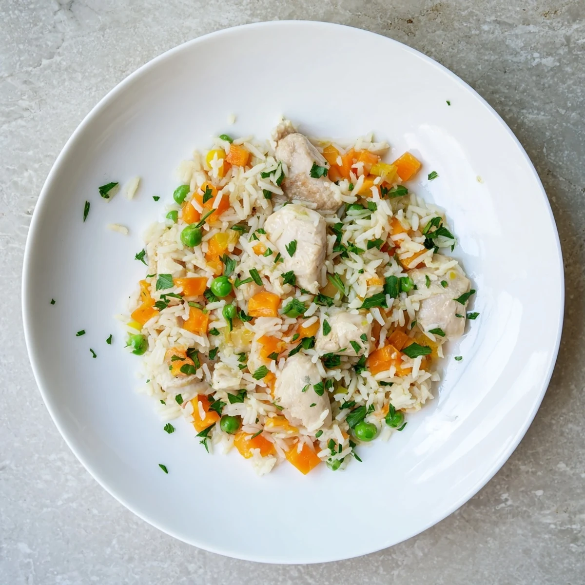 Tender chunks of seasoned chicken mixed with colorful carrots and green peas in this easy one-pot Instant Pot dinner