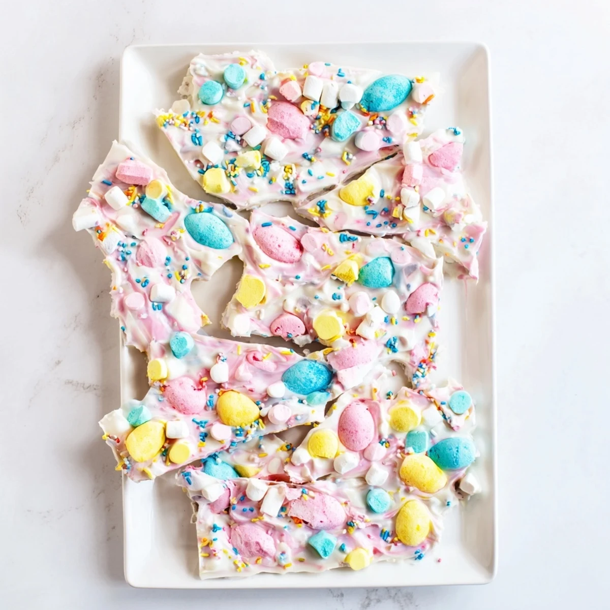 Creamy Easter marshmallow bark studded with pastel marshmallows, candy eggs, and colorful sprinkles