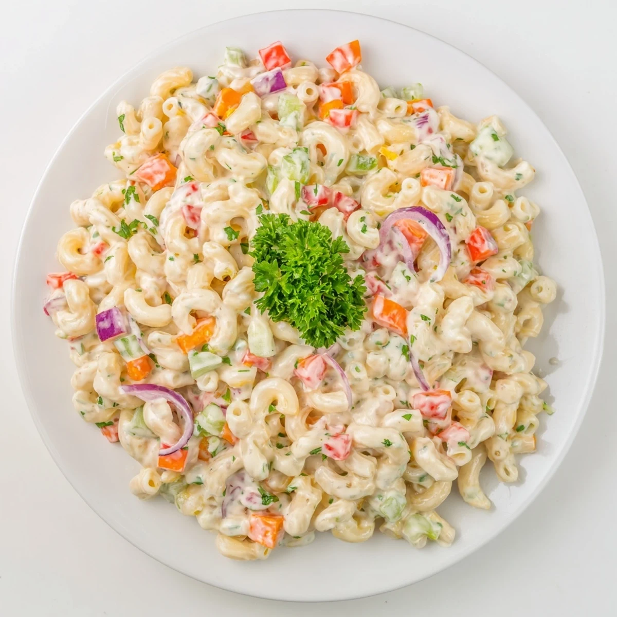 Scooped portion of tangy and creamy macaroni salad with fresh parsley garnish on rustic platter