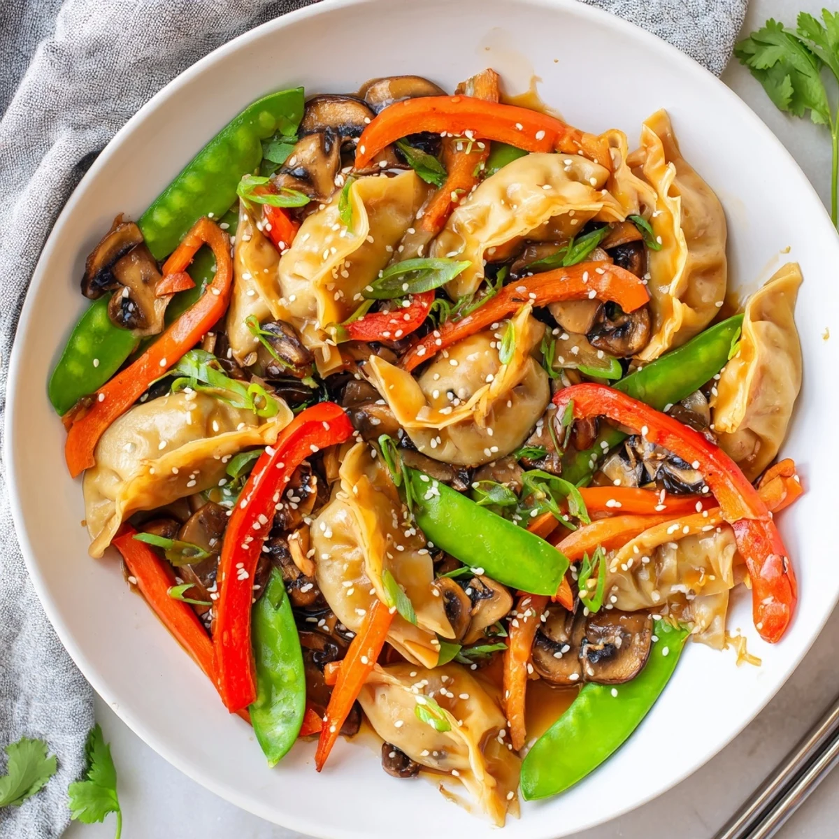 Golden potsticker stir fry with colorful snap peas and bell peppers in savory sauce