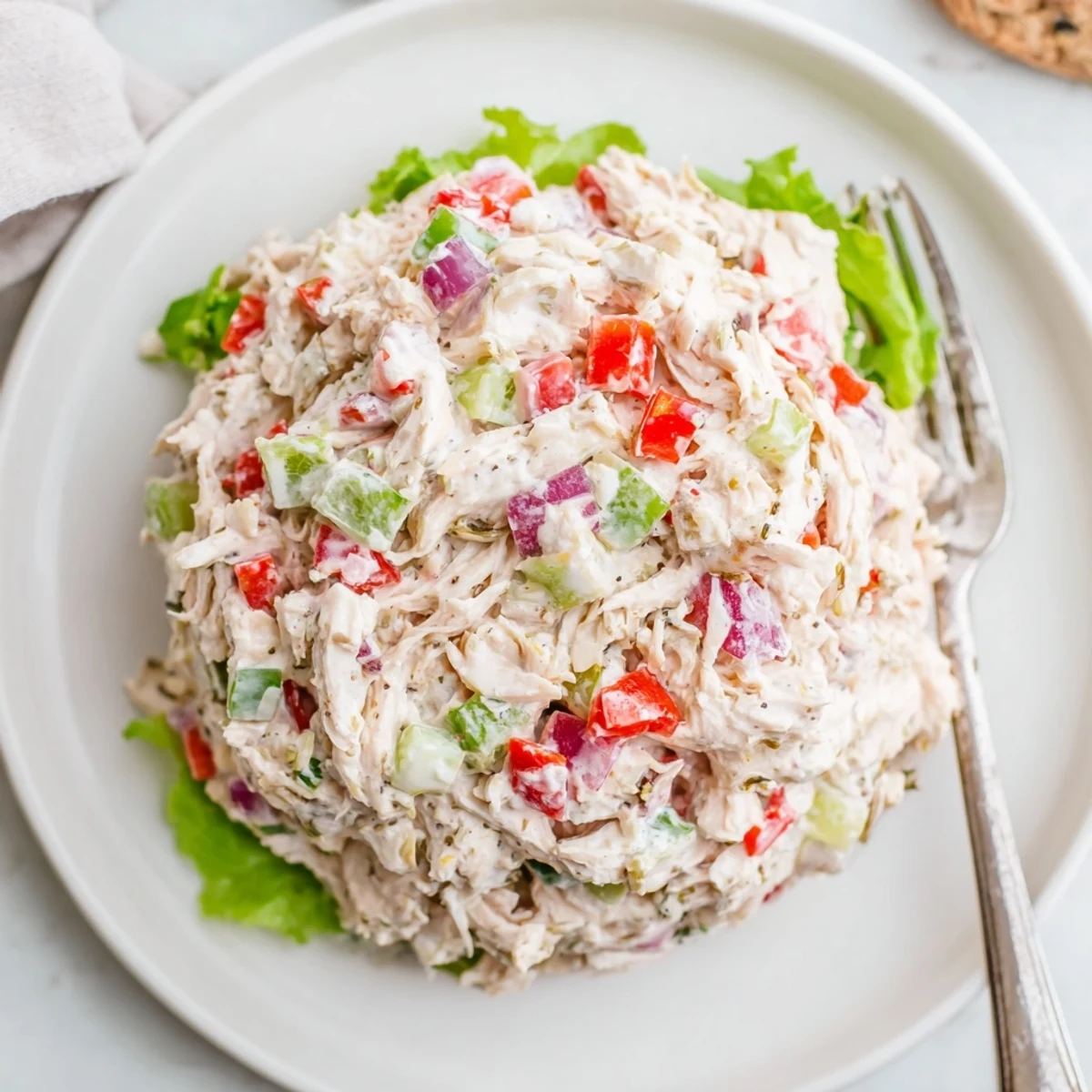 Bright High Protein Pepperoncini Chicken Salad chilled on mixed greens, zesty and crunchy