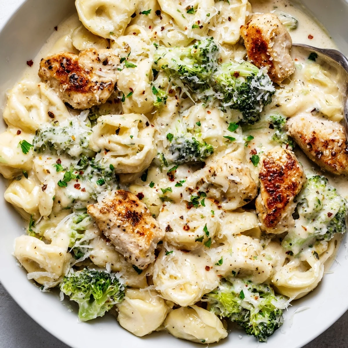 Creamy Garlic Parmesan Tortellini Chicken Broccoli Recipe with golden seared chicken and tender broccoli