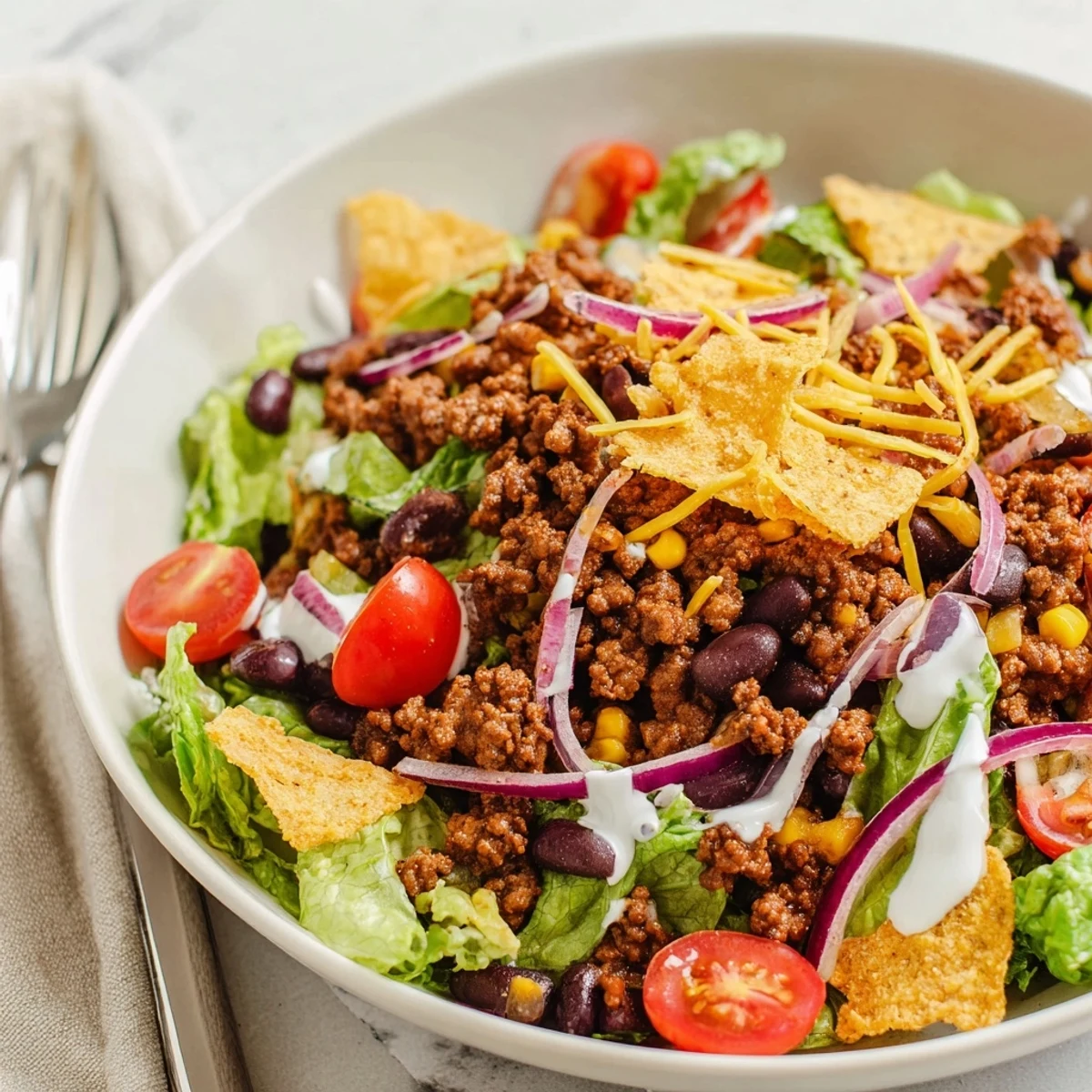 Simple Doritos Taco Salad on a platter, chips crisp, zesty dressing.