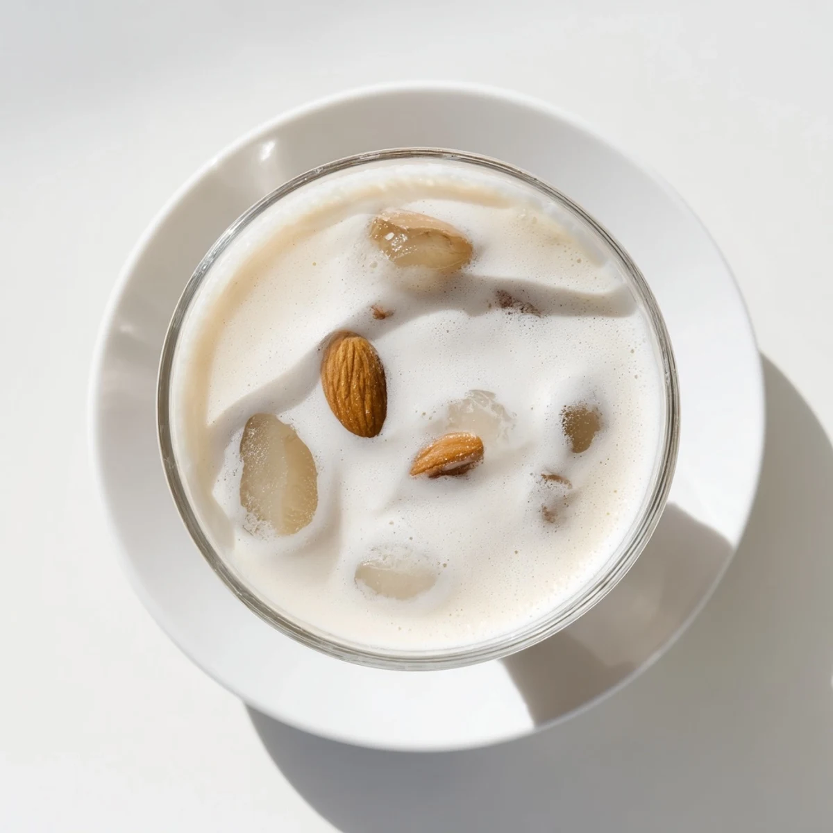 Refreshing summer almond milk beverage with creamy swirl and roasted almond garnish on ice