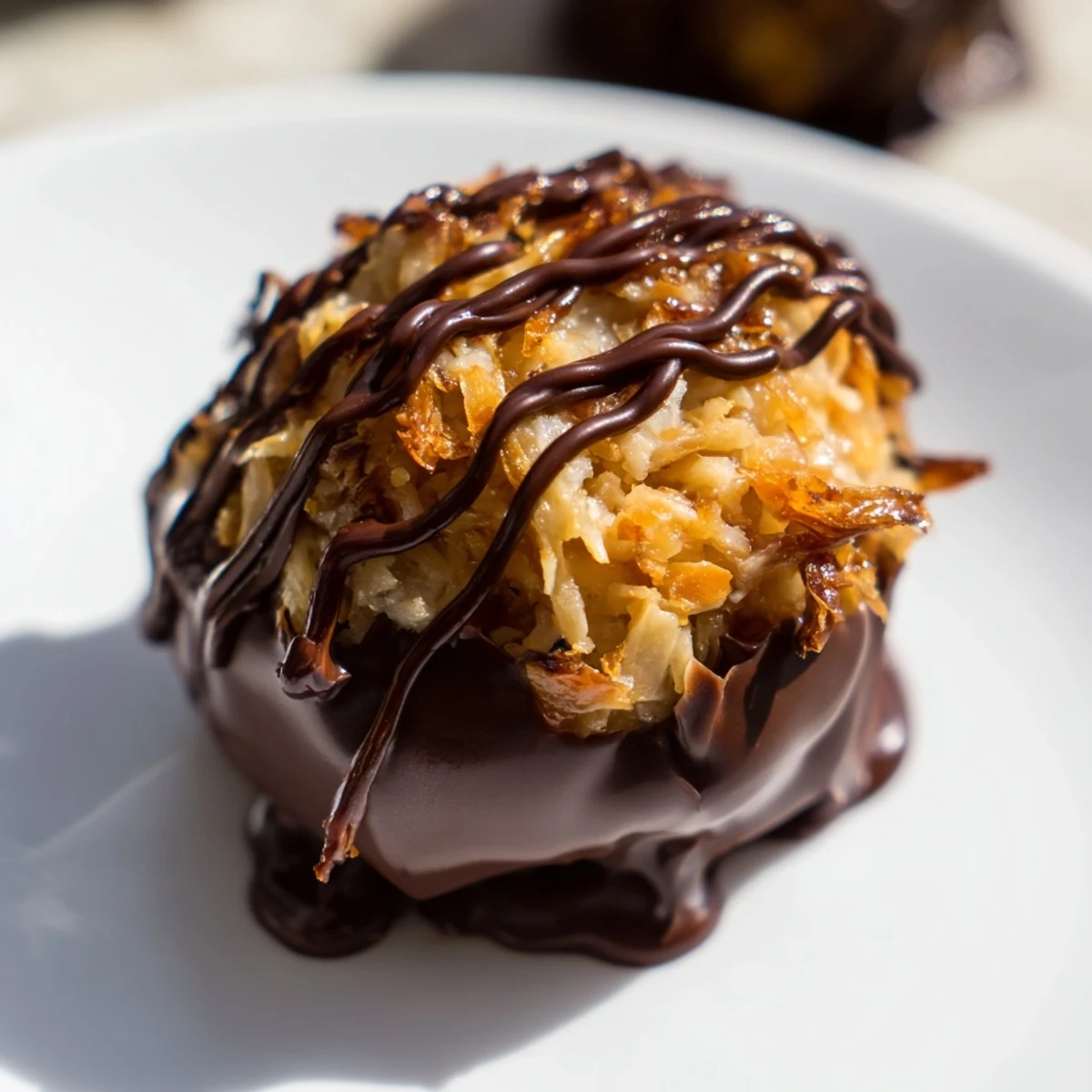 Chocolate-dipped no bake Samoa bites with toasted coconut caramel on parchment