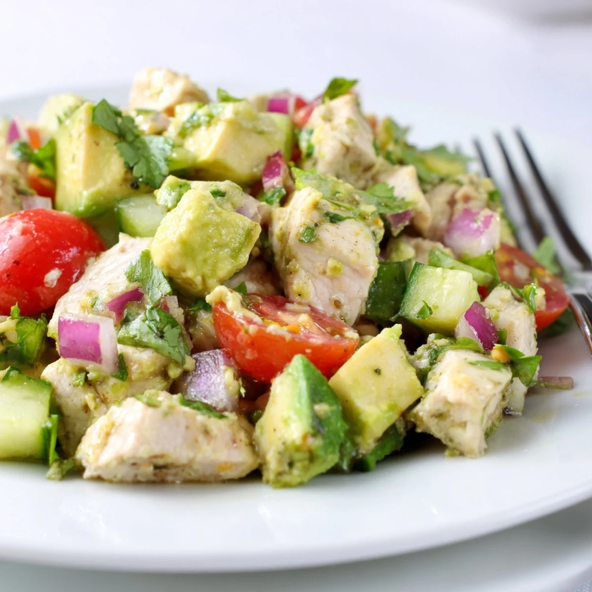 Avocado Chicken Salad on greens, creamy avocado and tender chicken, lime-scented.