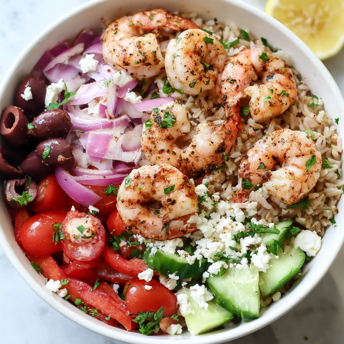 Colorful Greek shrimp Mediterranean bowl with olives tomatoes and zesty lemon dressing