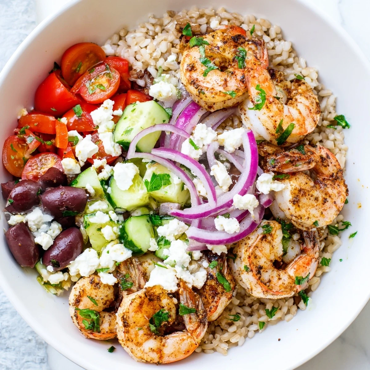 Succulent shrimp nestled over greens in a vibrant Greek shrimp Mediterranean bowl