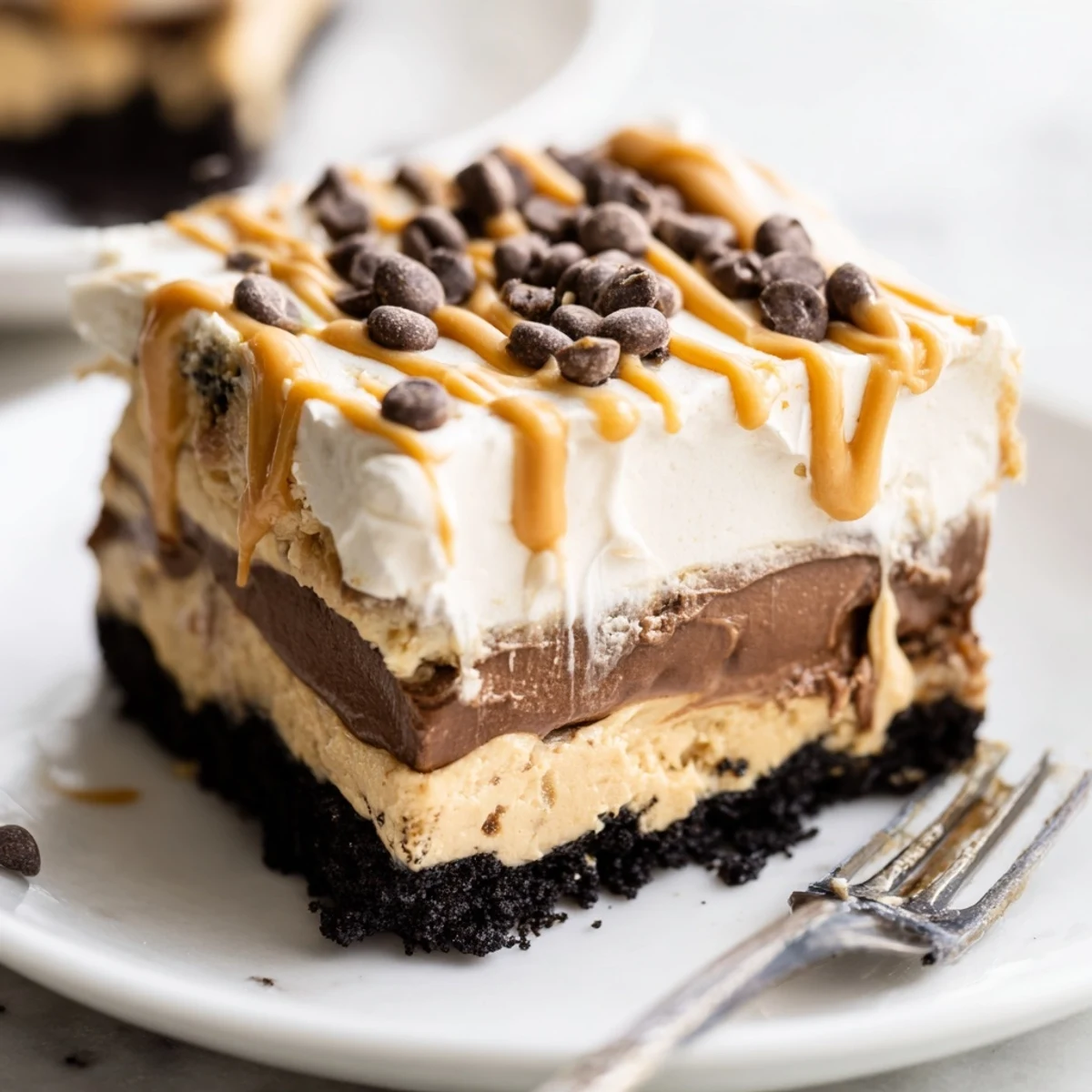 Golden drizzle over peanut butter layered delight in a chilled baking dish