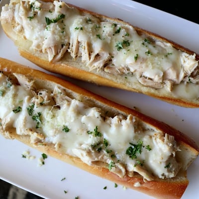 Viral Chicken Alfredo Garlic Bread is served in sliceable pieces perfect for sharing.