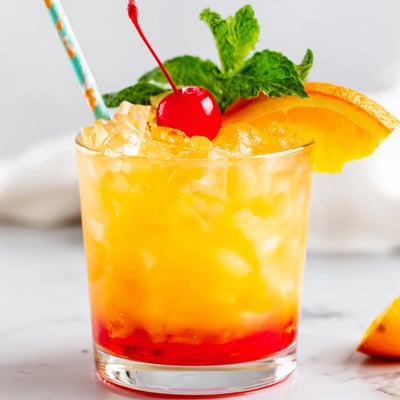 Vibrant non alcoholic Mai Tai in a glass with a beautiful red grenadine layer